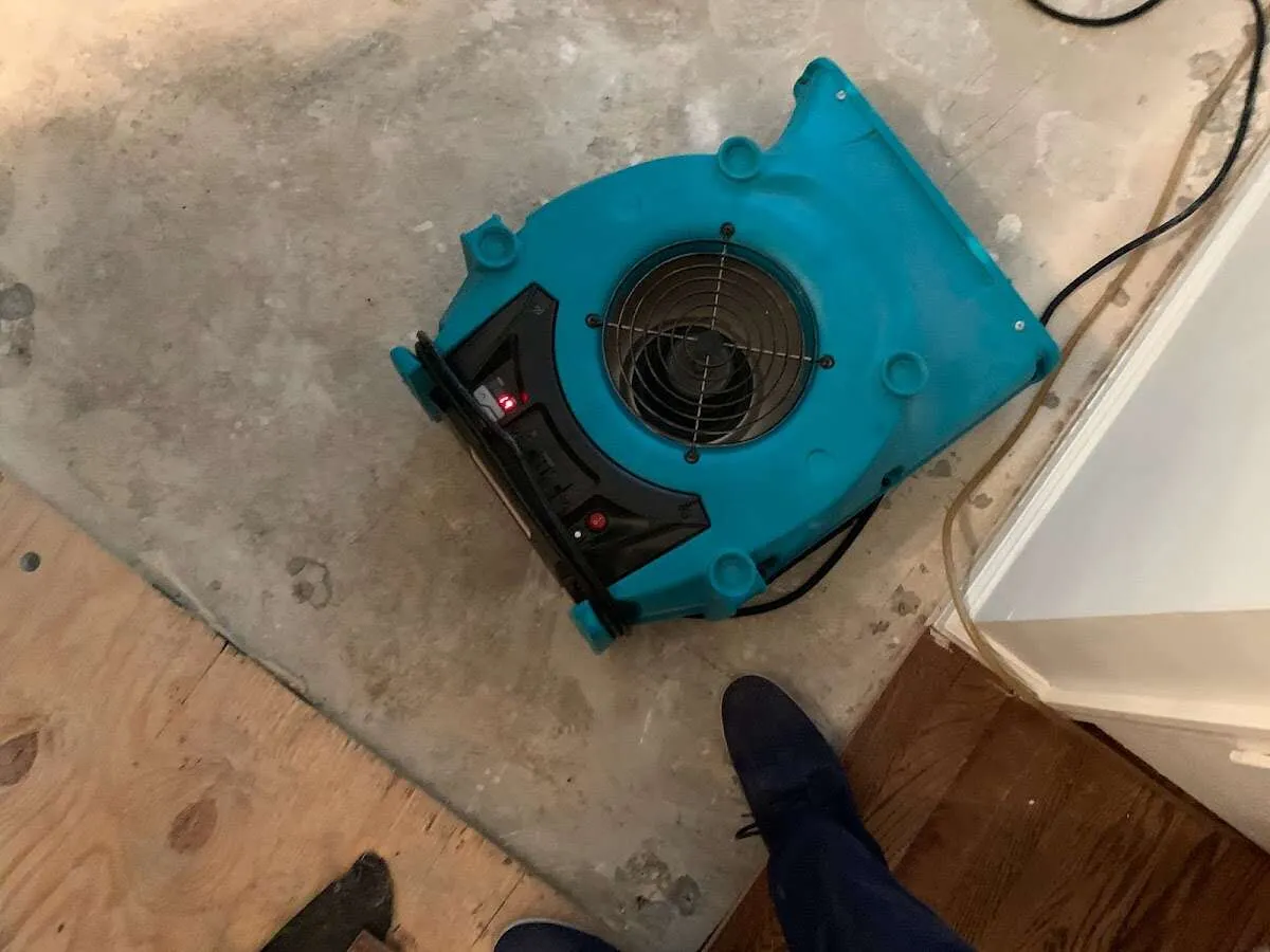 Air mover drying subfloor during Commercial Water Damage Restoration in Benton Harbor